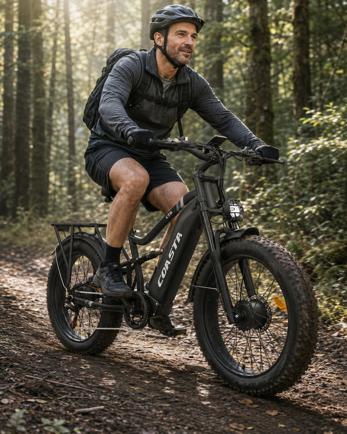 COASTA CT6 riding a forest trail in soft morning light